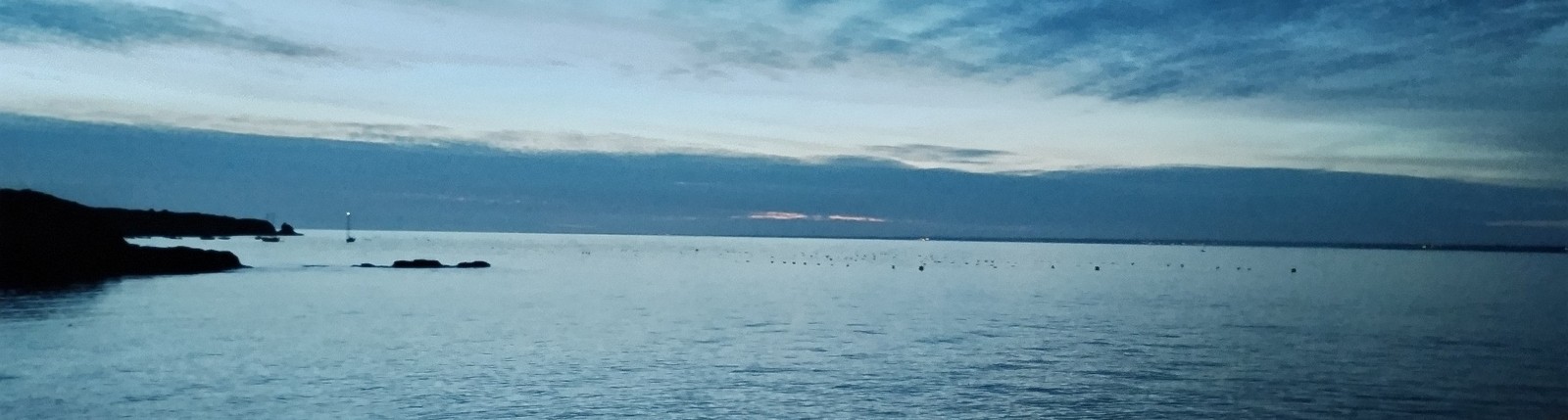 Nuit bleue au bord de la mer, horizon et ciel nuageux au crépuscule